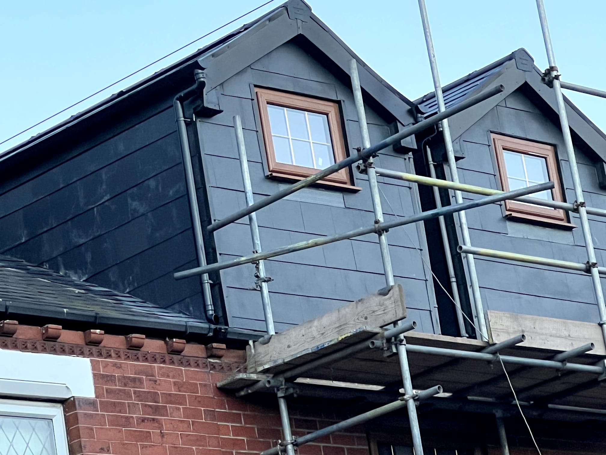 Dormer with slate-grey composite cladding and new windows